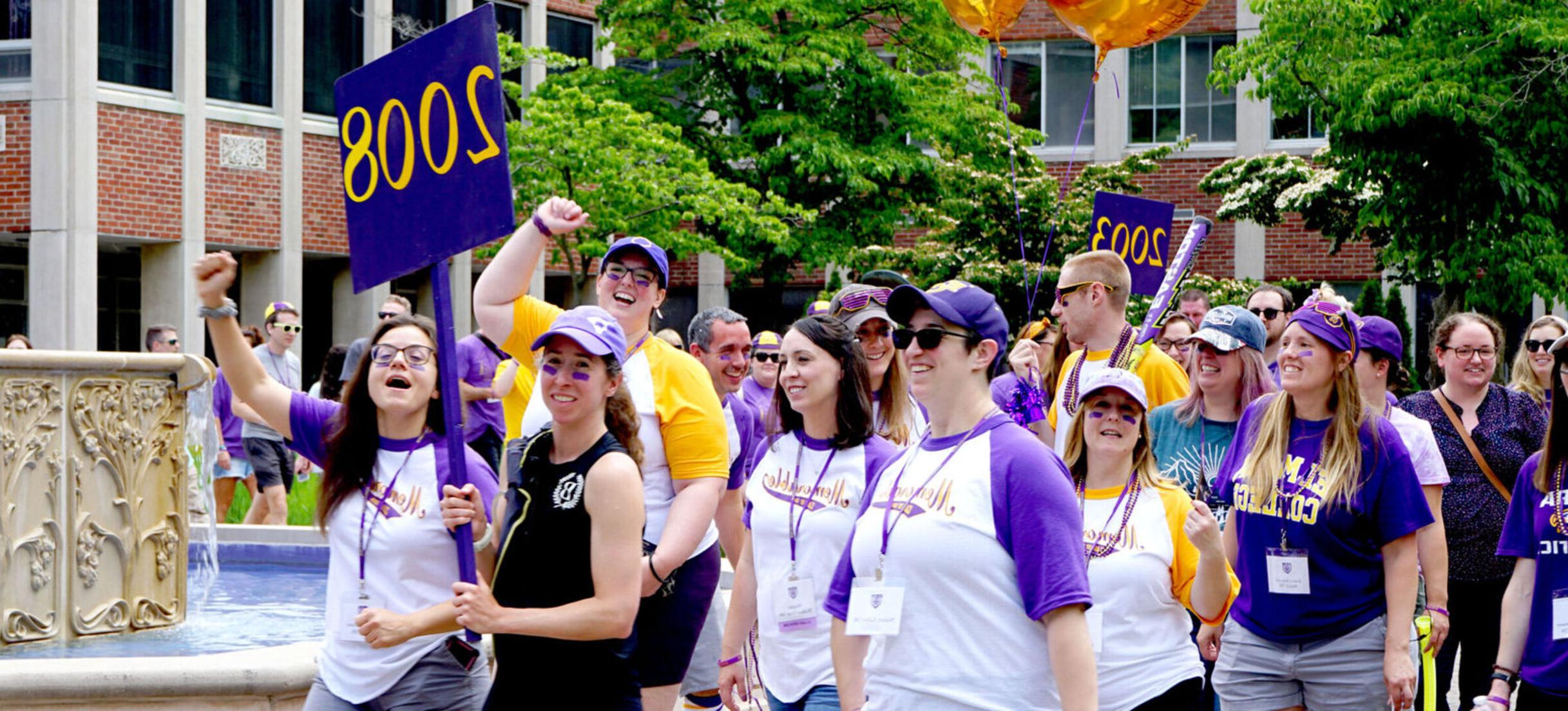 Members of the Class of 2008 cheer as they march in the Reunion 2023 parade